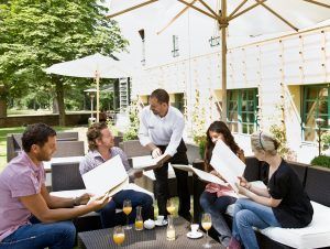Men and women talking over menus