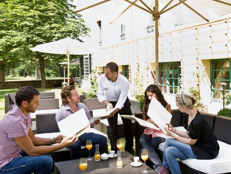 Men and women talking over menus